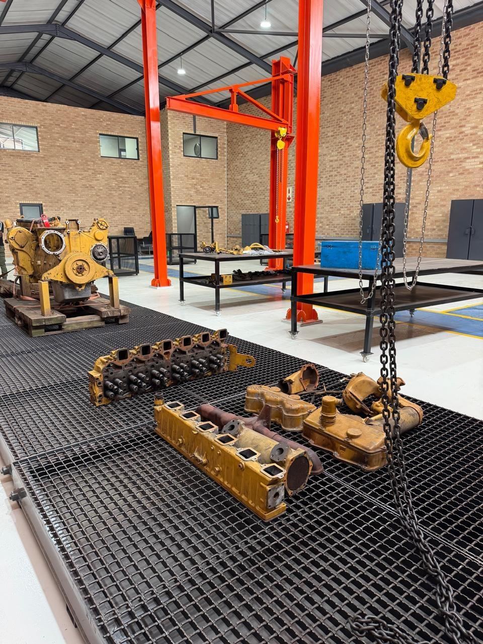 Big Struqtive Holding workshop with overhead chain hoist and components