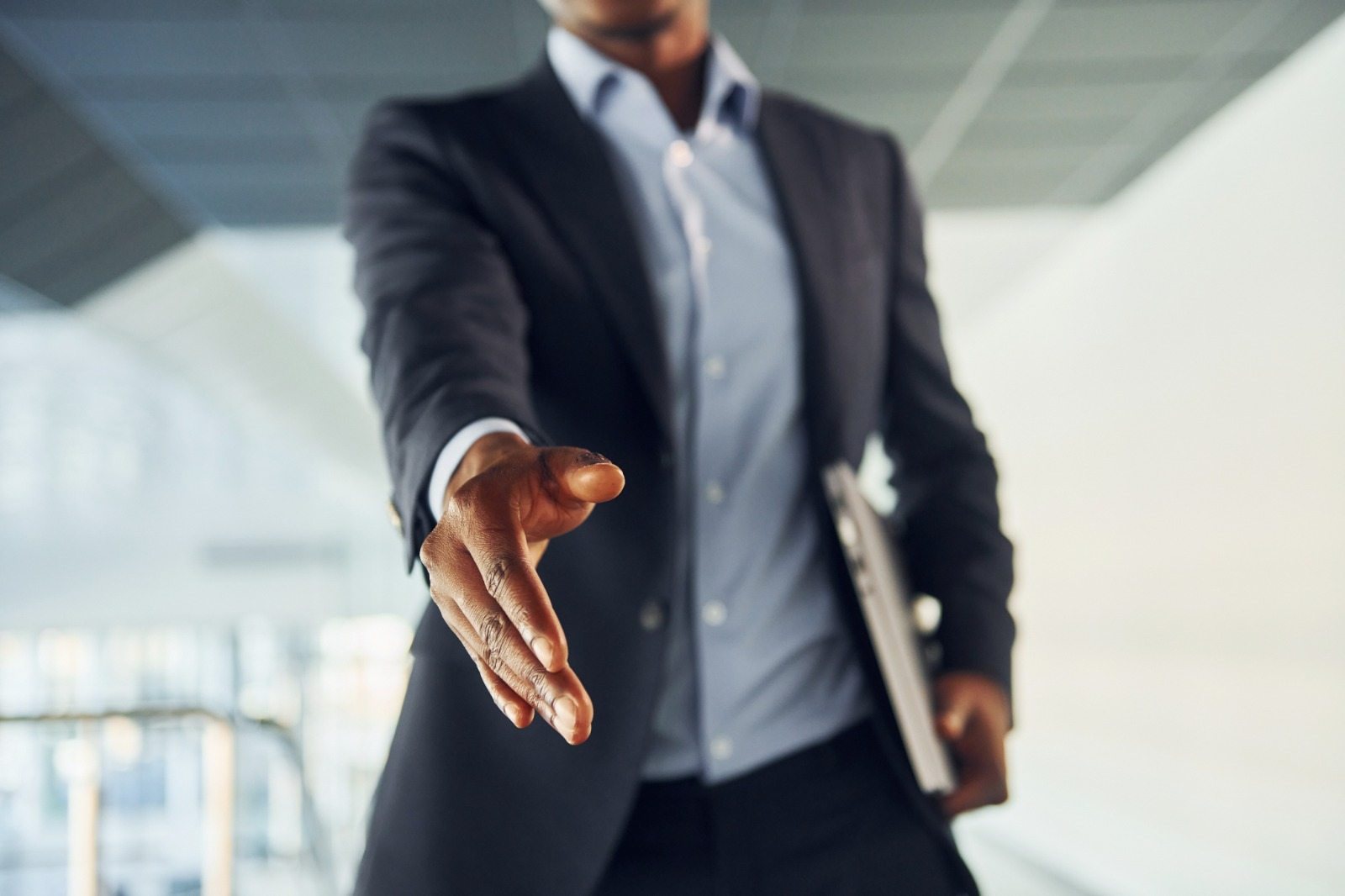 A professional extending a handshake